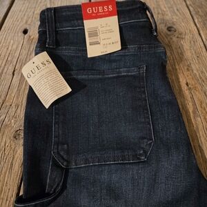 These Guess brand women's dark wash jeans feature a straight-leg style